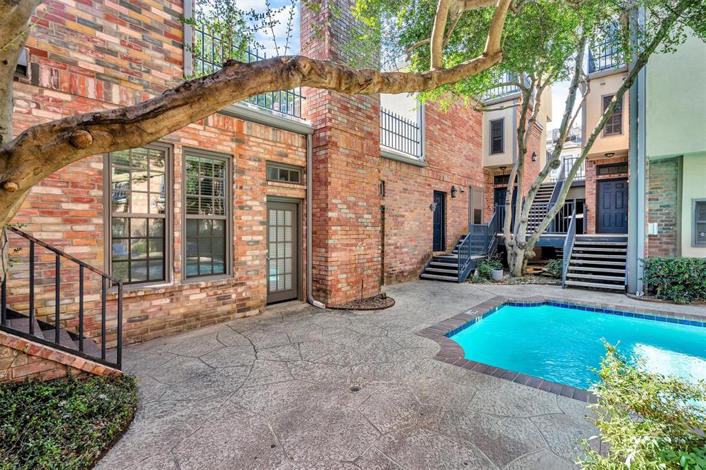 4511 Gilbert Avenue, Unit 108 Dallas, TX 75219 - Photo 1 of 25 a view of a house with brick walls