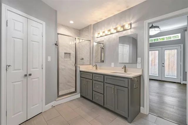 a bathroom with a double vanity sink and a mirror