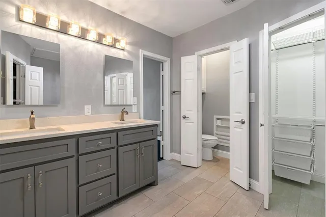 a spacious bathroom with a double vanity sink mirror and a shower