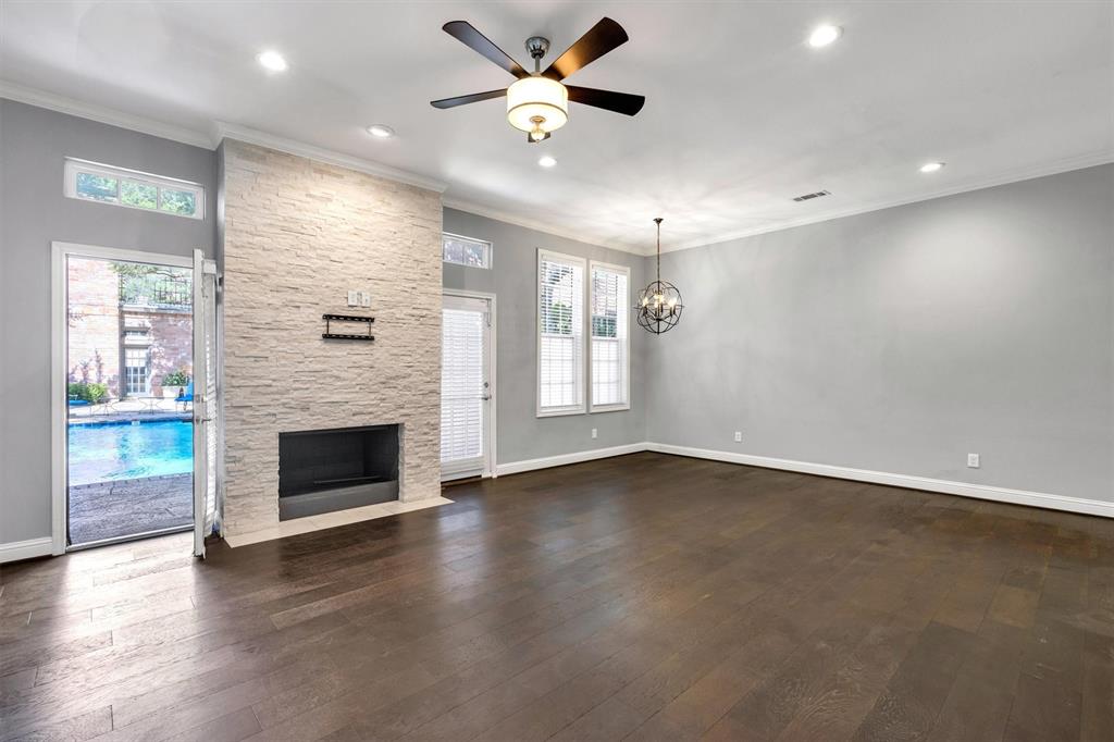 4511 Gilbert Avenue, Unit 108 Dallas, TX 75219 - Photo 4 of 25 a view of an empty room with a fireplace and a window