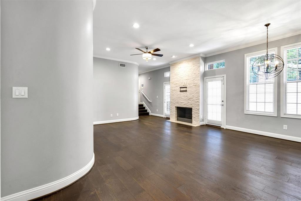 4511 Gilbert Avenue, Unit 108 Dallas, TX 75219 - Photo 5 of 25 an empty room with windows and fireplace
