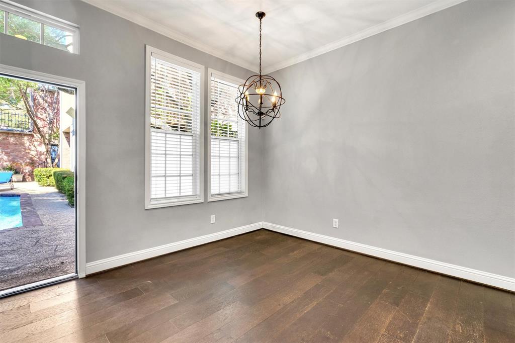 4511 Gilbert Avenue, Unit 108 Dallas, TX 75219 - Photo 6 of 25 a view of a room with wooden floor chandelier and windows