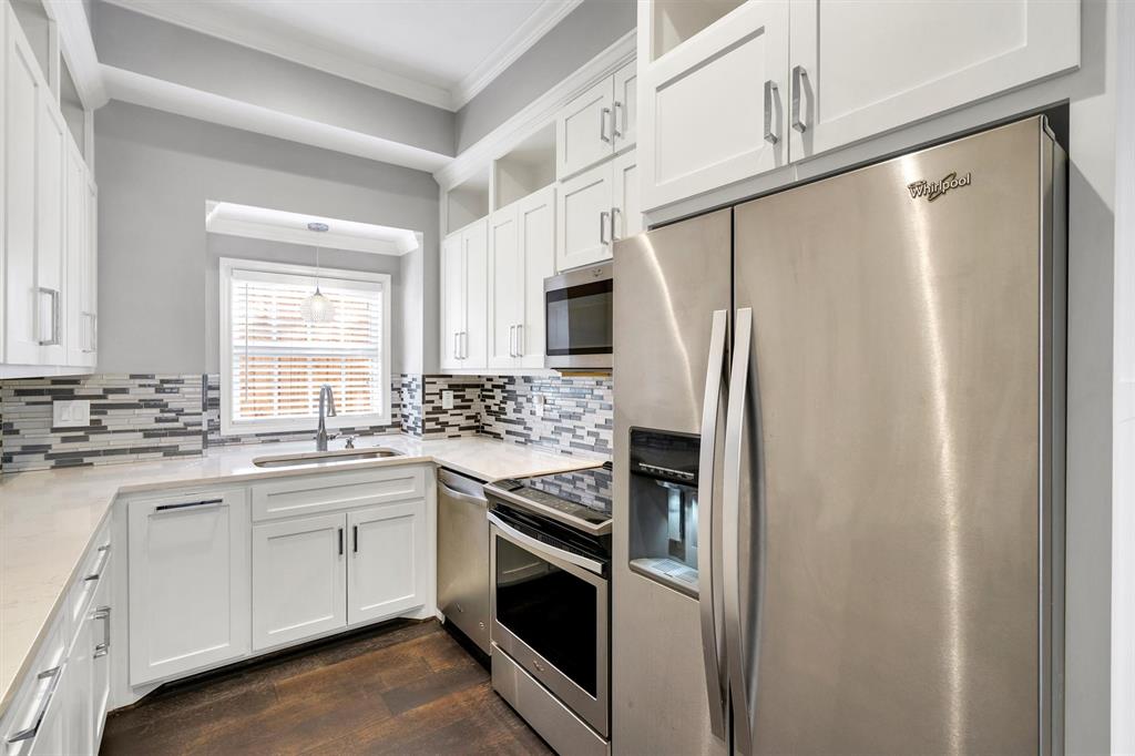 4511 Gilbert Avenue, Unit 108 Dallas, TX 75219 - Photo 8 of 25 a kitchen with stainless steel appliances a refrigerator sink and microwave
