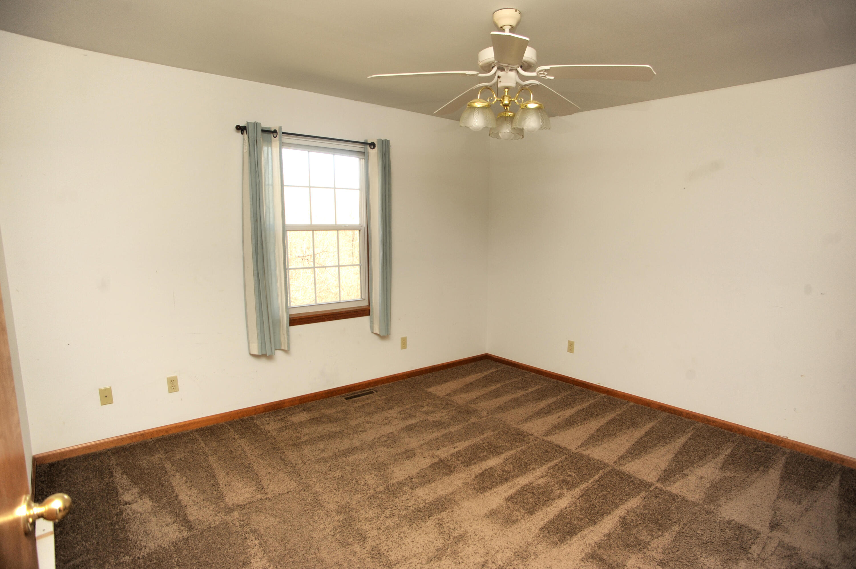 216 Summertree Drive Porter, IN 46304 - Photo 19 of 28 an empty room with a chandelier fan and windows