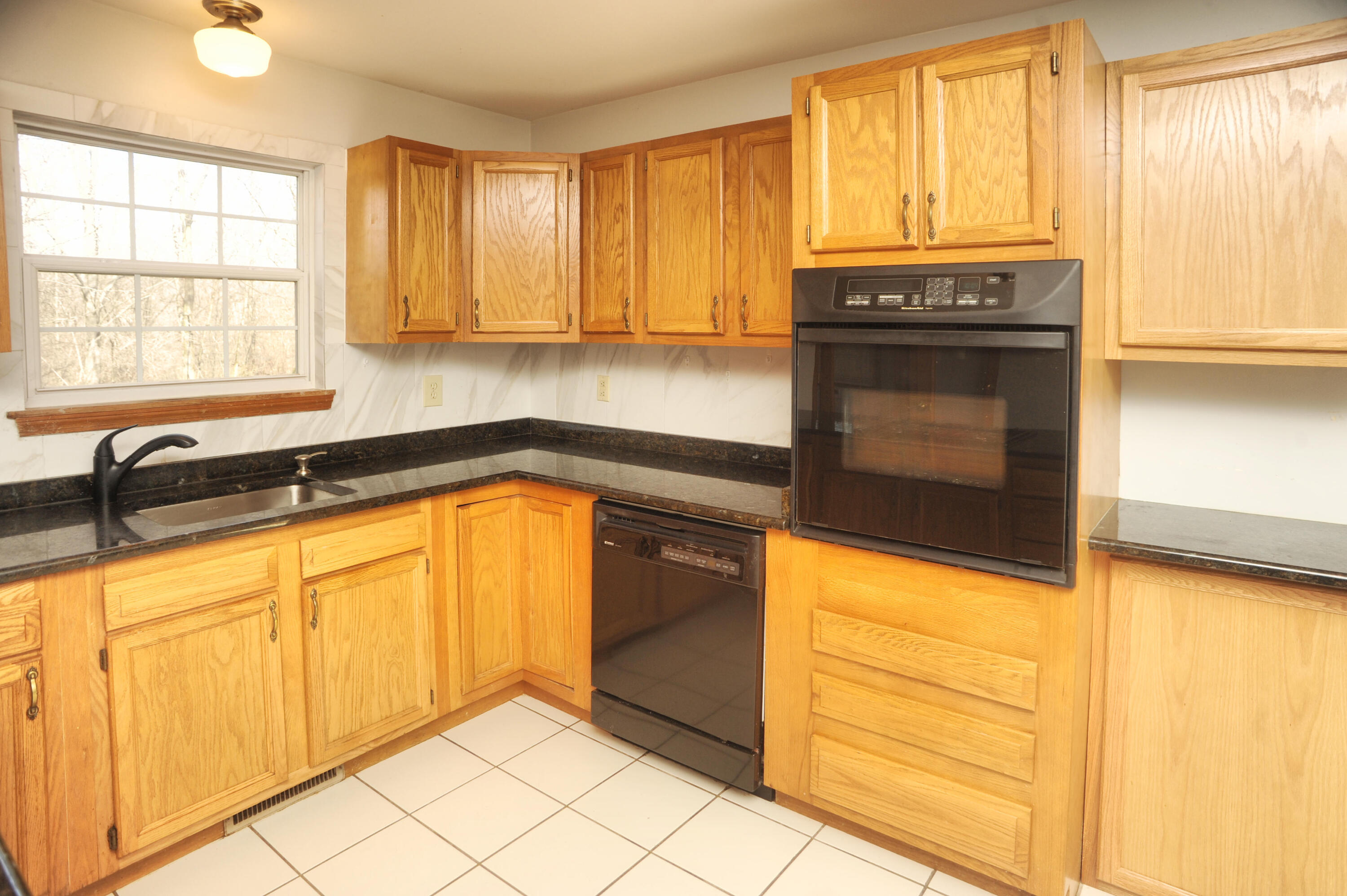 216 Summertree Drive Porter, IN 46304 - Photo 26 of 28 a kitchen with stainless steel appliances granite countertop a stove a sink and a microwave