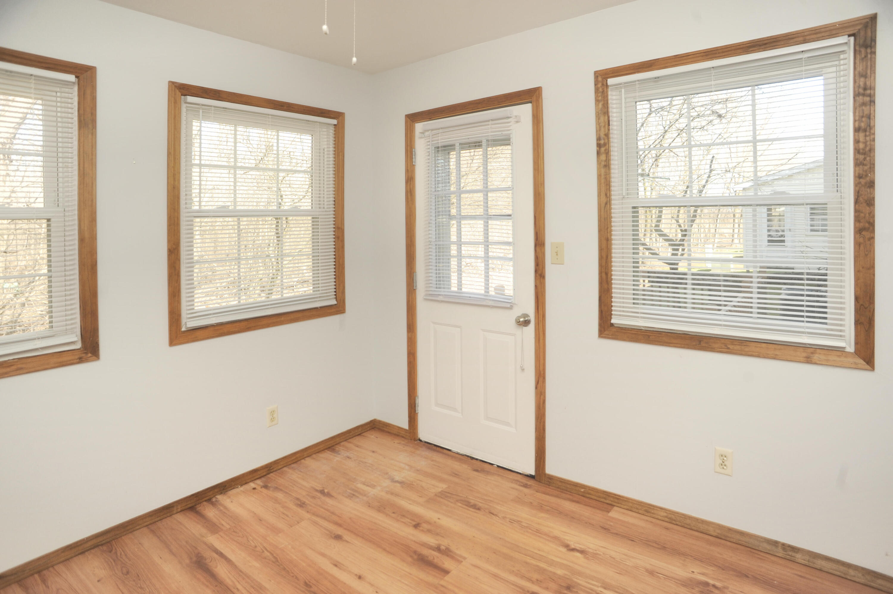 216 Summertree Drive Porter, IN 46304 - Photo 6 of 28 a view of an empty room with wooden floor and a window