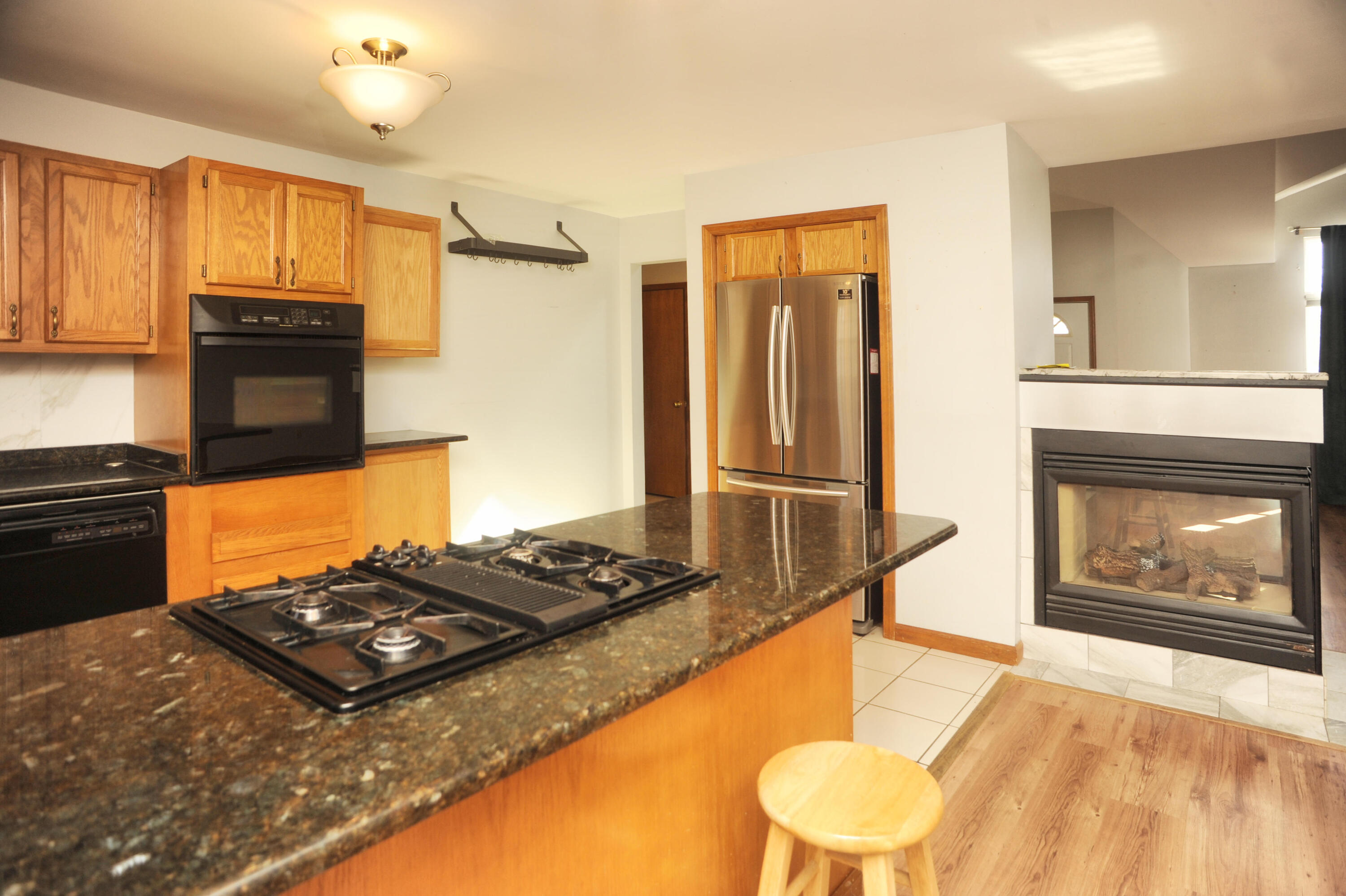 216 Summertree Drive Porter, IN 46304 - Photo 7 of 28 a kitchen with a stove and a refrigerator