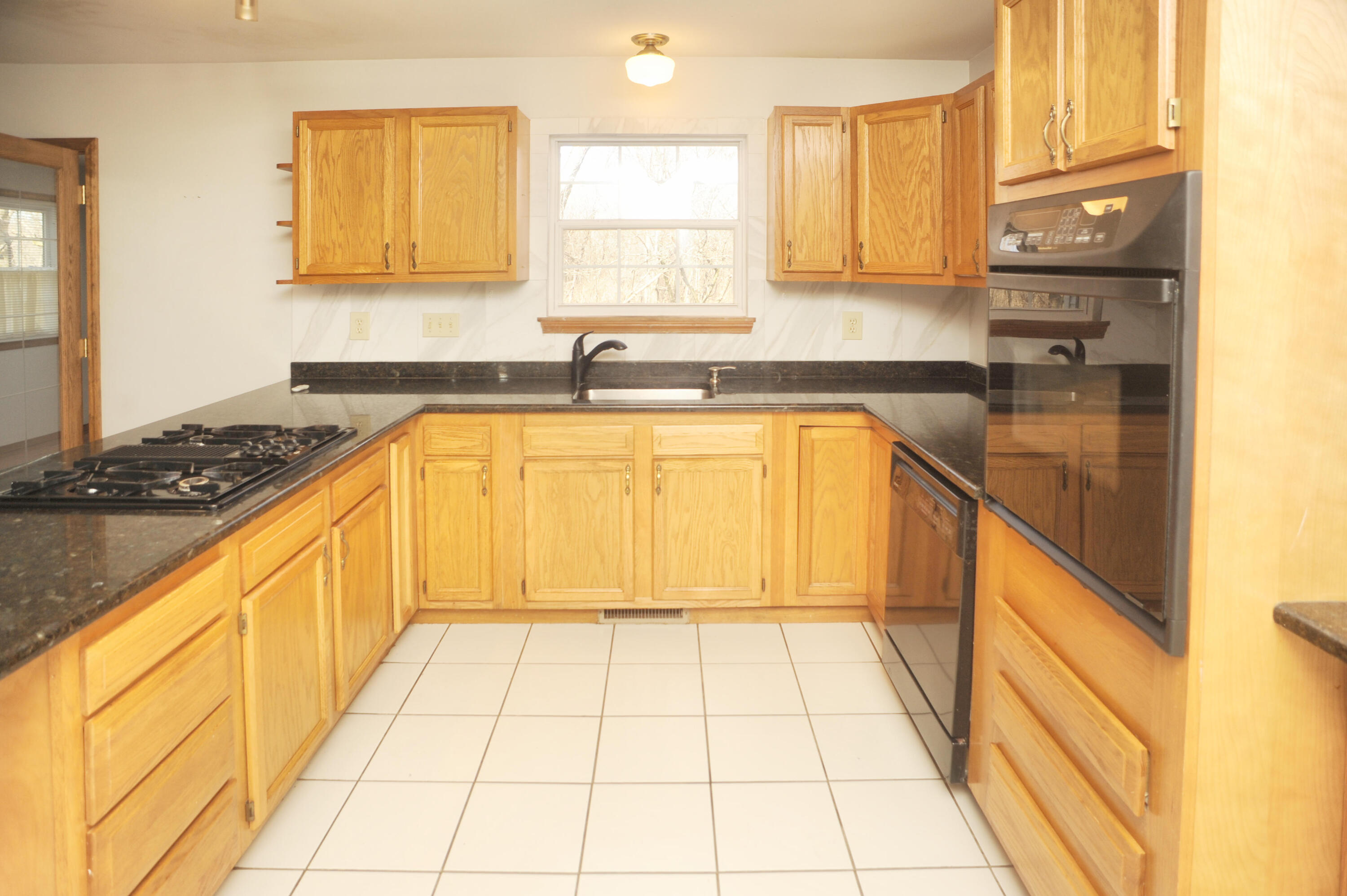 216 Summertree Drive Porter, IN 46304 - Photo 8 of 28 a kitchen with stainless steel appliances granite countertop a stove a sink and a microwave