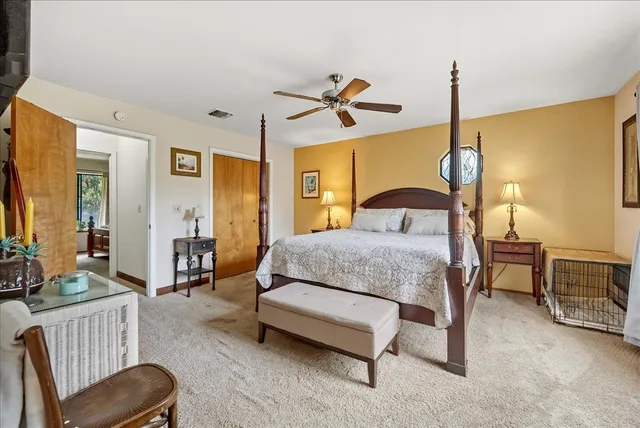 a spacious bathroom with double vanity a mirror and double