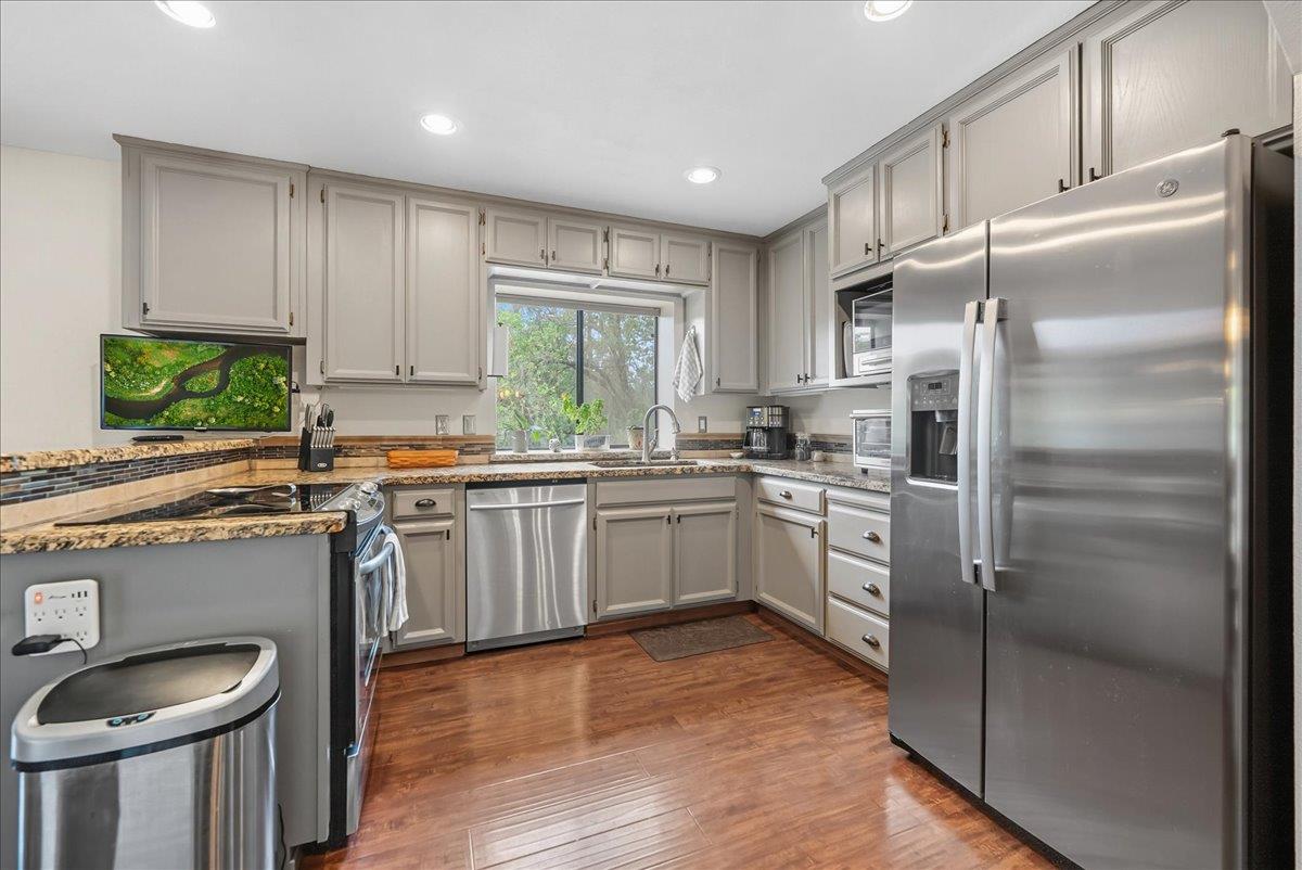 2527 Dynamic Way Rescue, CA 95672 - Photo 6 of 37 a kitchen with a refrigerator a sink a stove and cabinets