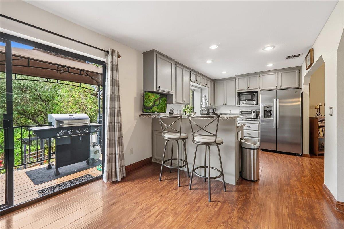 2527 Dynamic Way Rescue, CA 95672 - Photo 7 of 37 a kitchen with stainless steel appliances granite countertop a refrigerator a stove top oven and a wooden floors