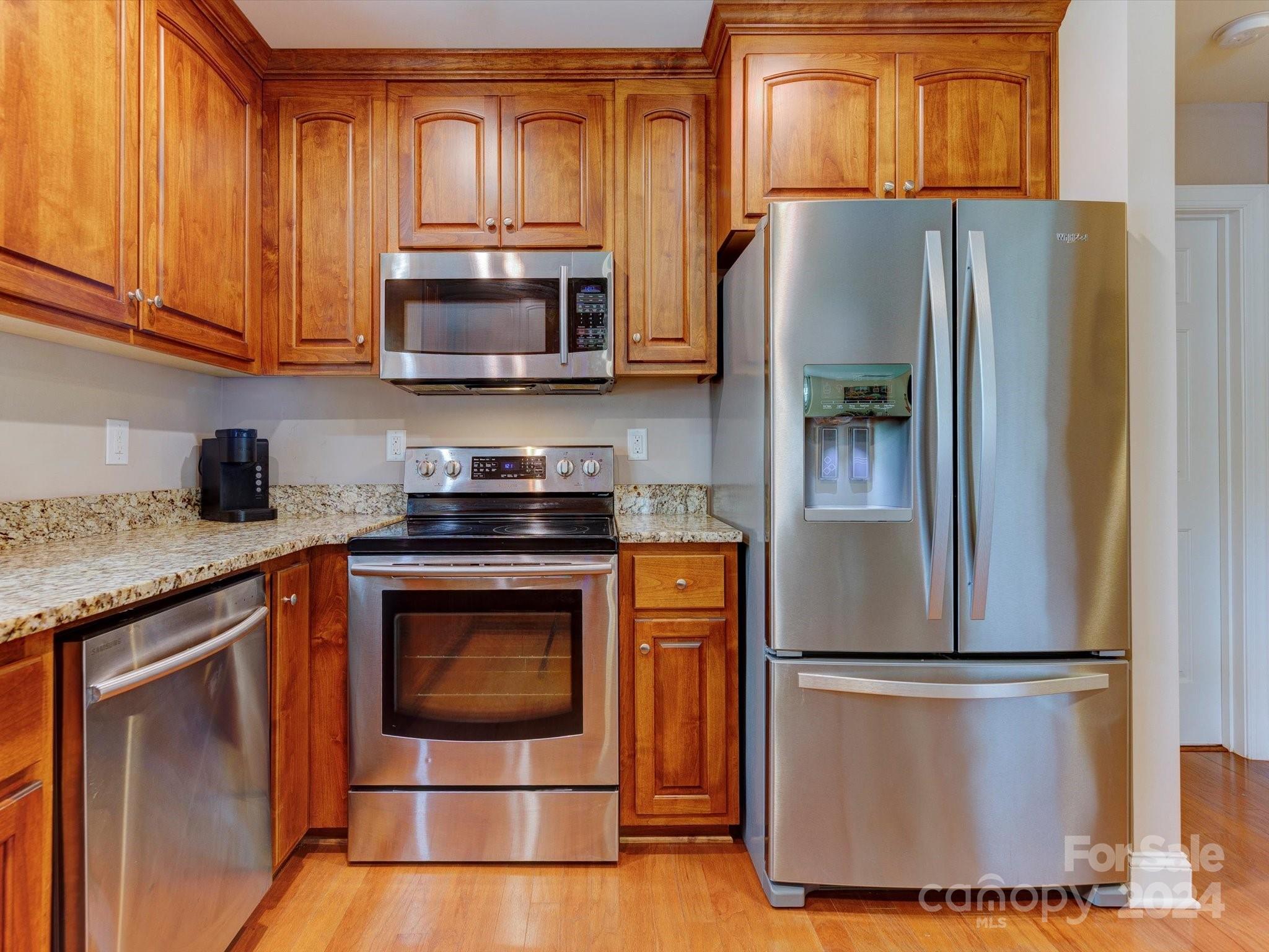 4403 Zee Court Monroe, NC 28110 - Photo 11 of 35 a kitchen with stainless steel appliances granite countertop a refrigerator stove and microwave