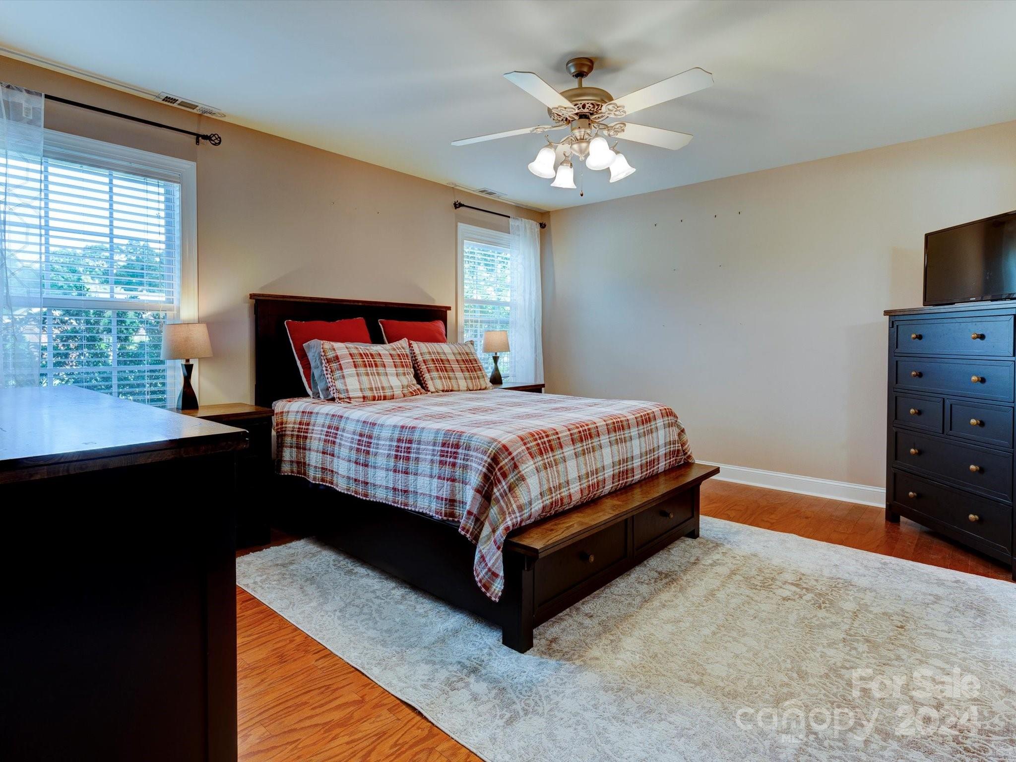 4403 Zee Court Monroe, NC 28110 - Photo 12 of 35 a bedroom with a bed and a chandelier