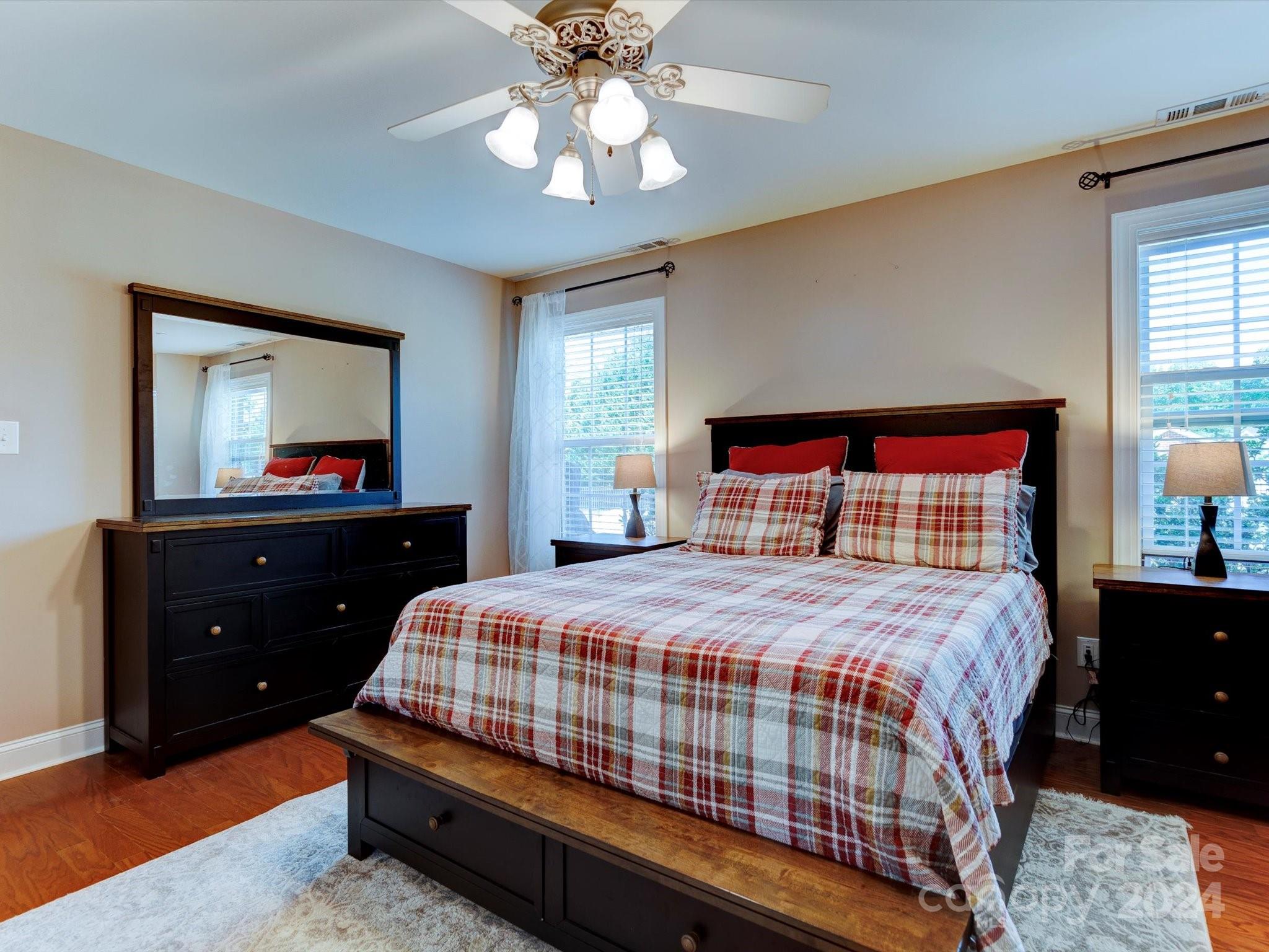 4403 Zee Court Monroe, NC 28110 - Photo 13 of 35 a bedroom with a bed and a mirror on dresser