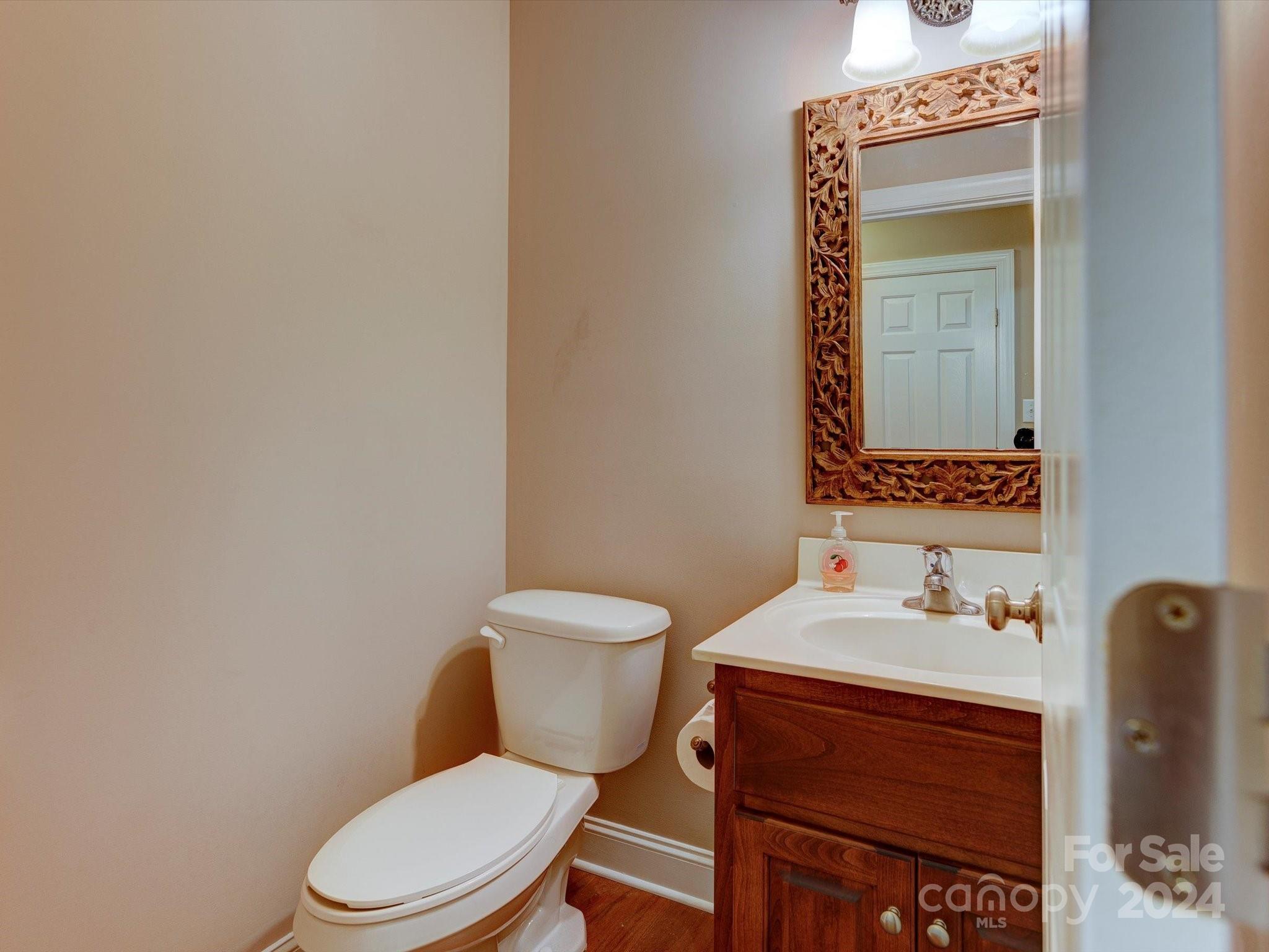 4403 Zee Court Monroe, NC 28110 - Photo 16 of 35 a white toilet sitting next to a bathroom sink