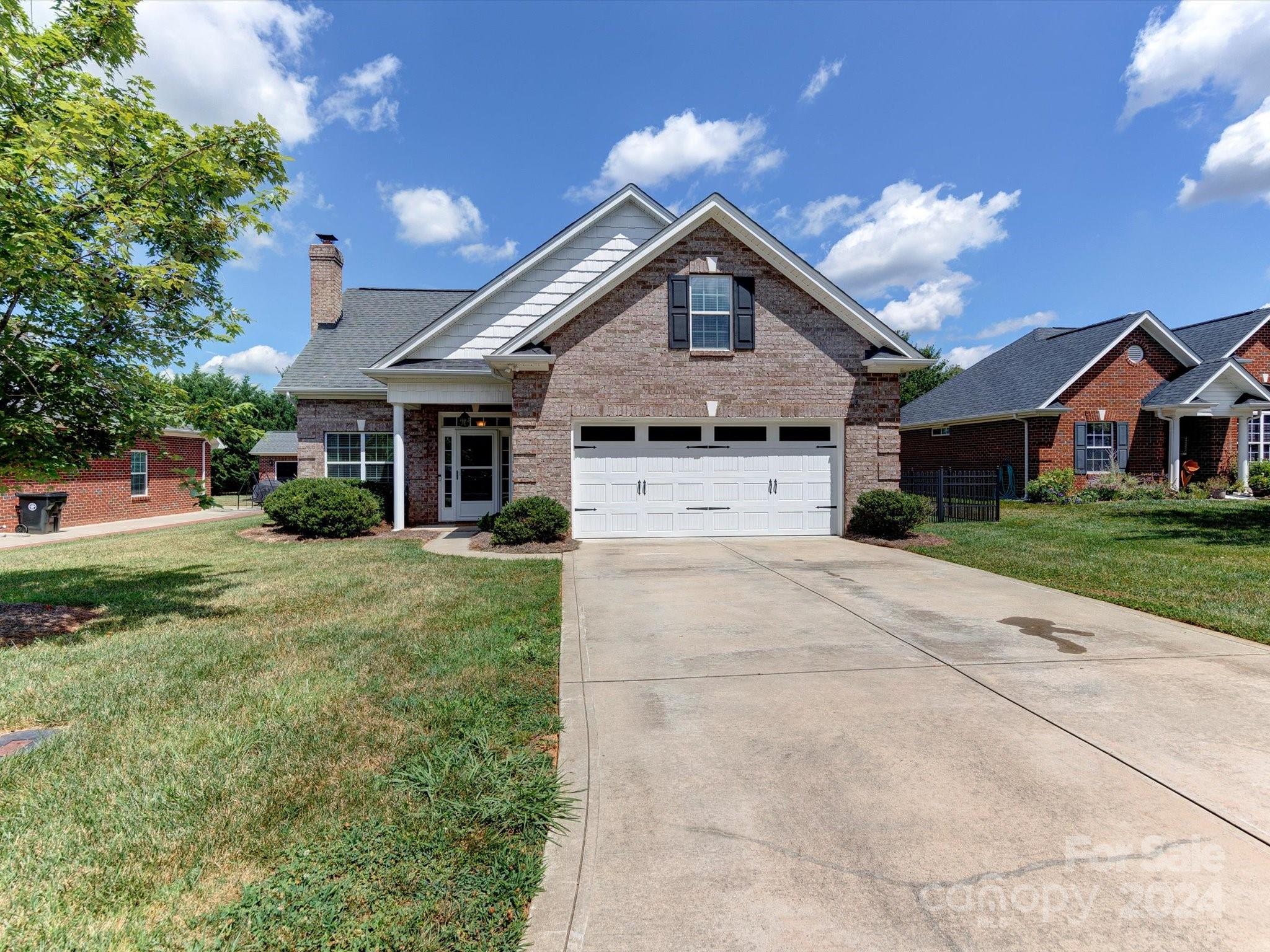 4403 Zee Court Monroe, NC 28110 - Photo 2 of 35 a front view of a house with a yard and garage