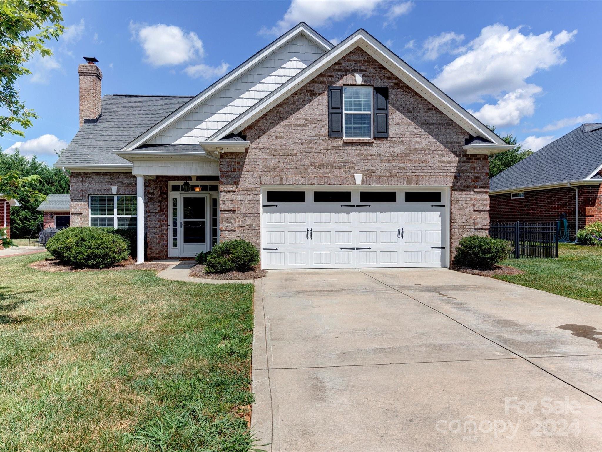 4403 Zee Court Monroe, NC 28110 - Photo 3 of 35 a front view of a house with a yard and garage