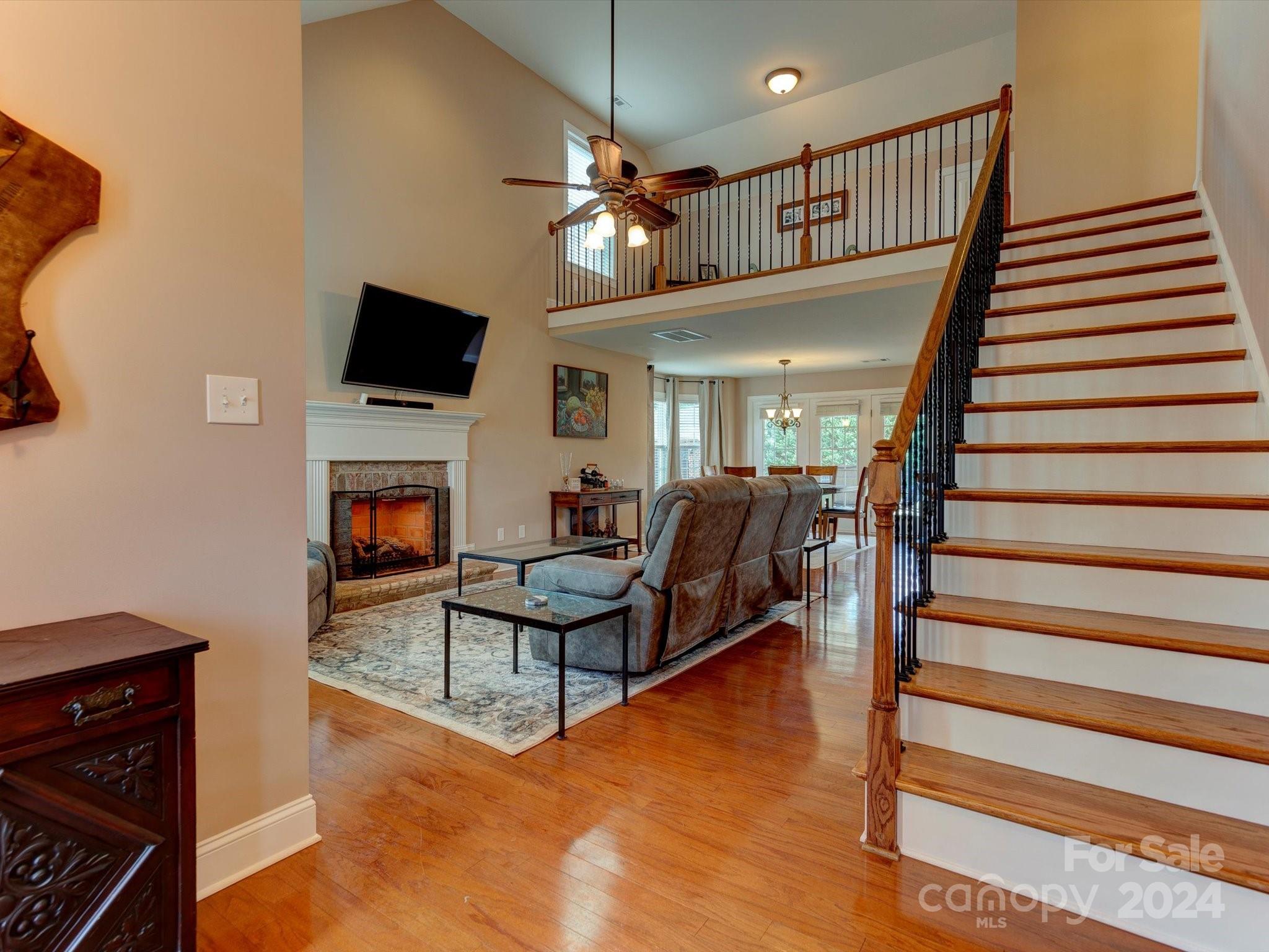 4403 Zee Court Monroe, NC 28110 - Photo 5 of 35 a living room with furniture a flat screen tv and a fireplace
