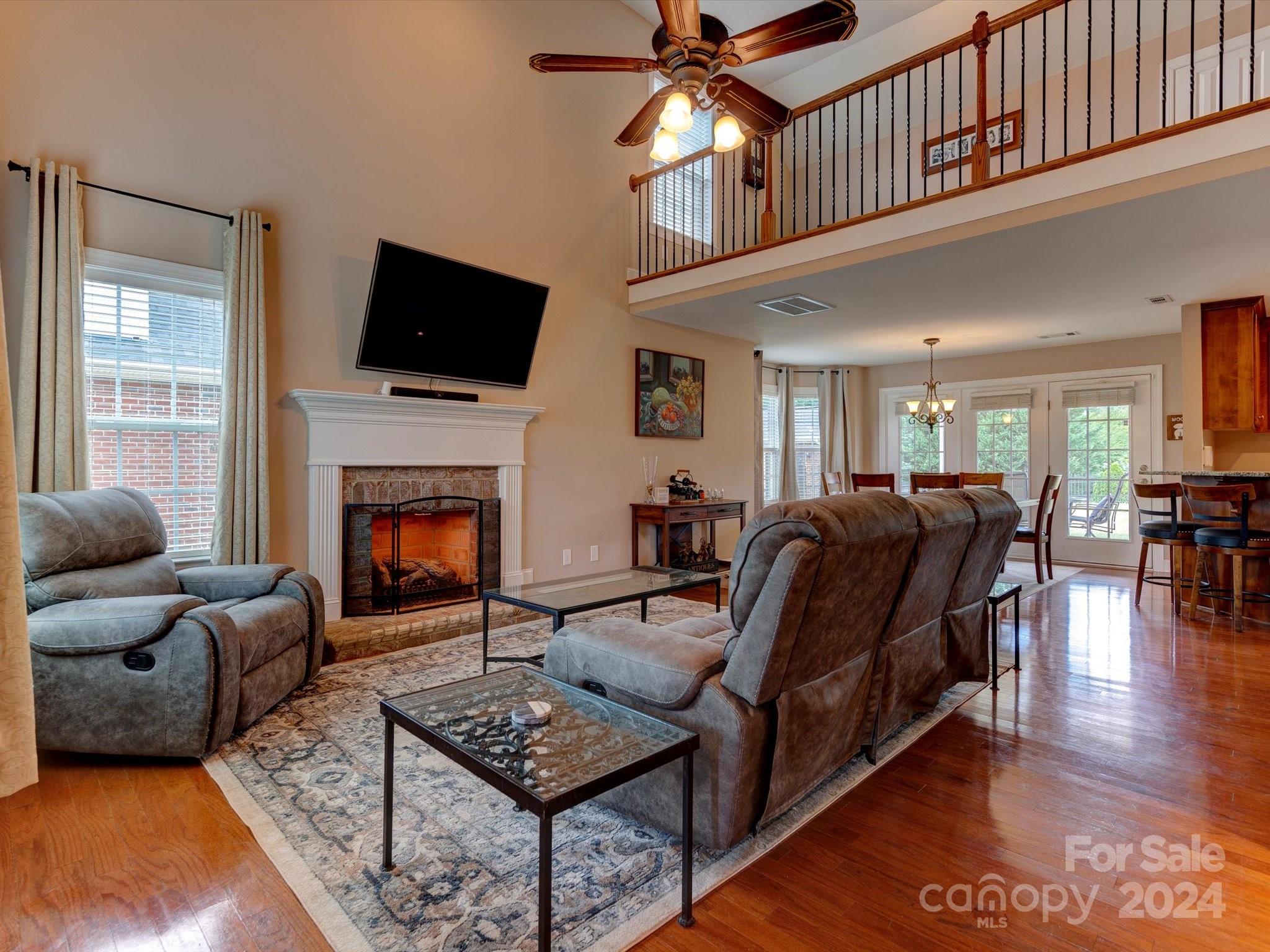 4403 Zee Court Monroe, NC 28110 - Photo 6 of 35 a living room with furniture a flat screen tv and a fireplace