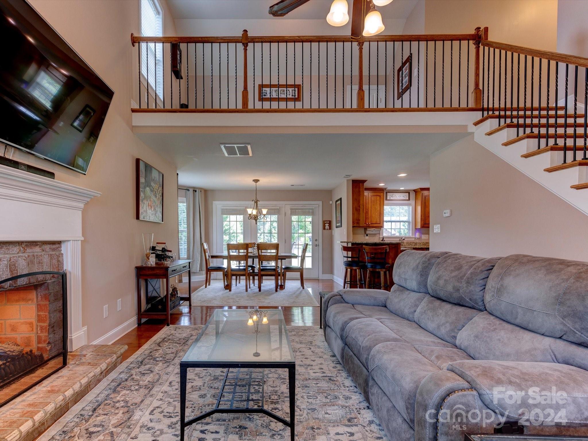 4403 Zee Court Monroe, NC 28110 - Photo 7 of 35 a living room with furniture a flat screen tv and a fireplace
