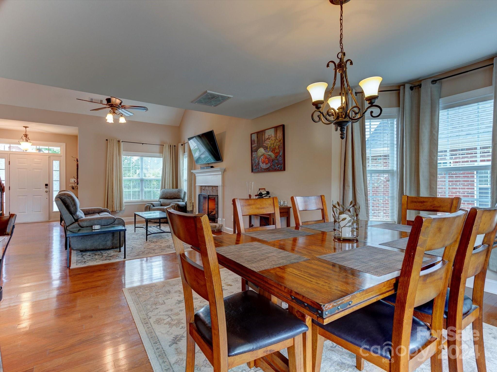 4403 Zee Court Monroe, NC 28110 - Photo 9 of 35 a view of a dining room with furniture a chandelier and wooden floor