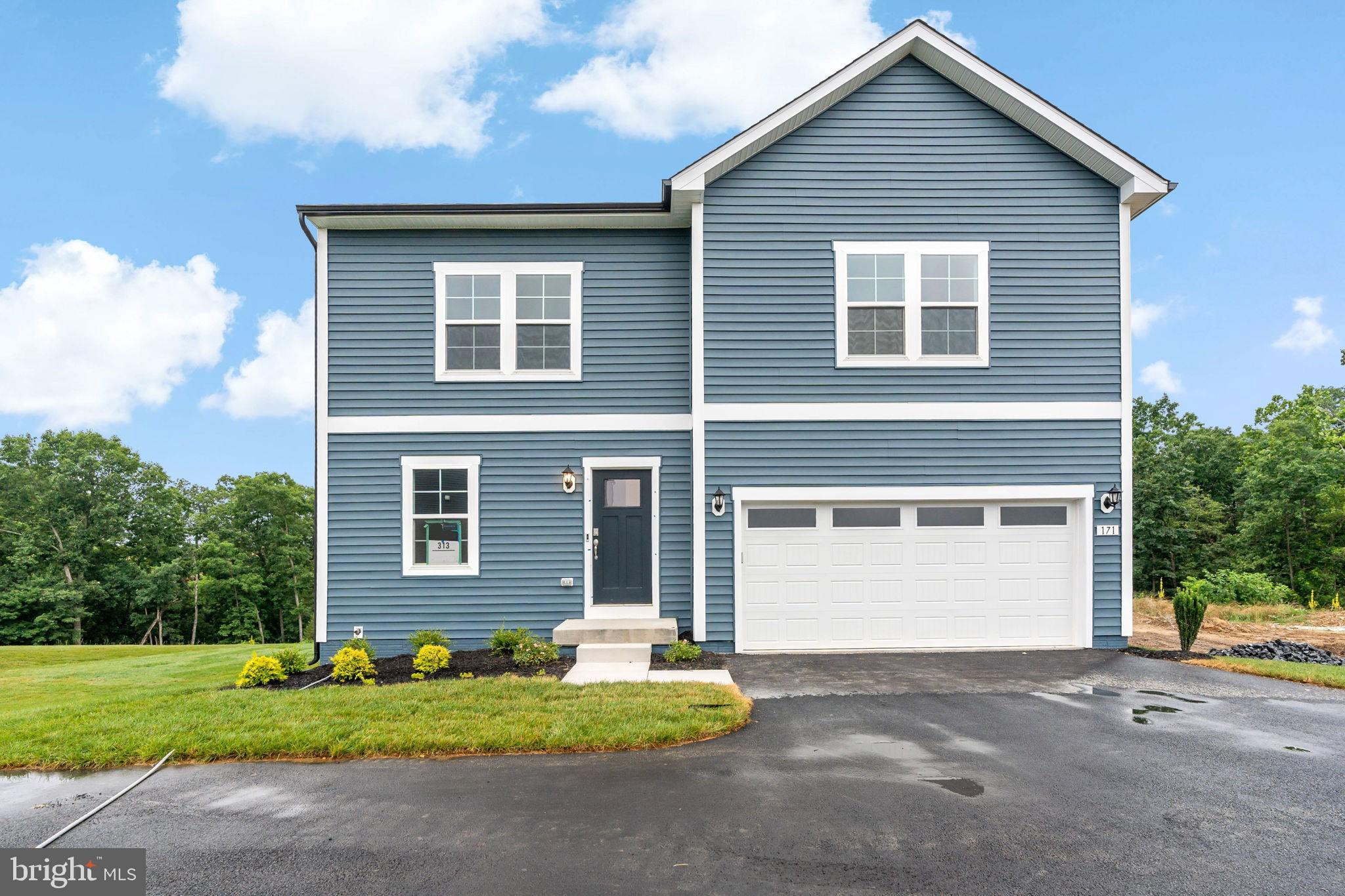 171 Grayling Road Inwood, WV 25428 - Photo 1 of 39 a front view of a house with a yard and garage