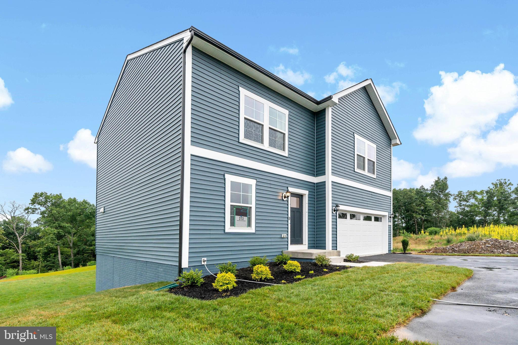171 Grayling Road Inwood, WV 25428 - Photo 2 of 39 a front view of a house with a yard and garage