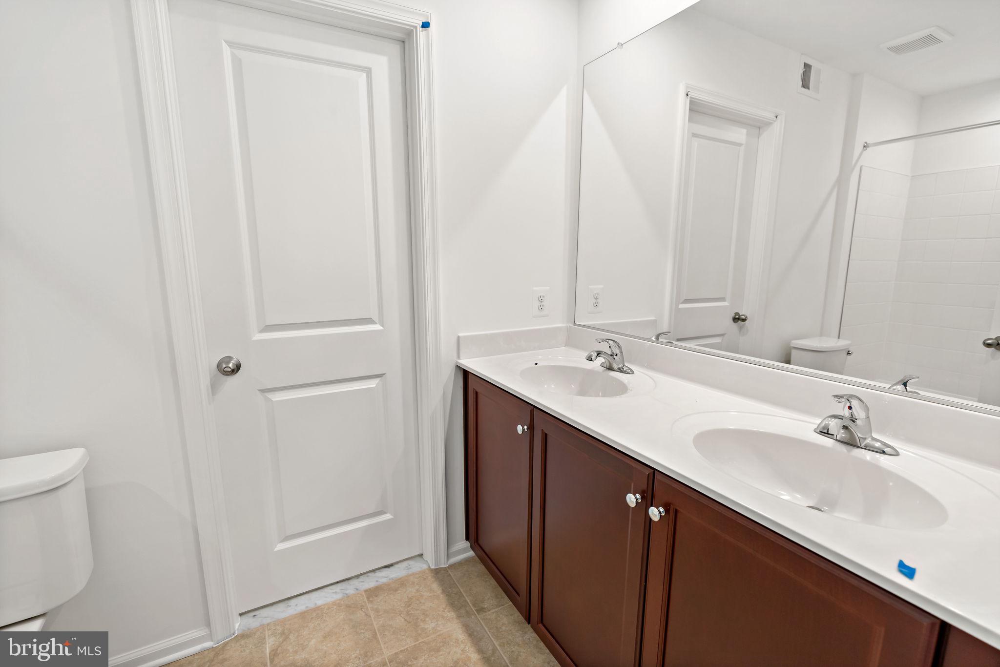 171 Grayling Road Inwood, WV 25428 - Photo 24 of 39 a bathroom with a double vanity sink and a mirror