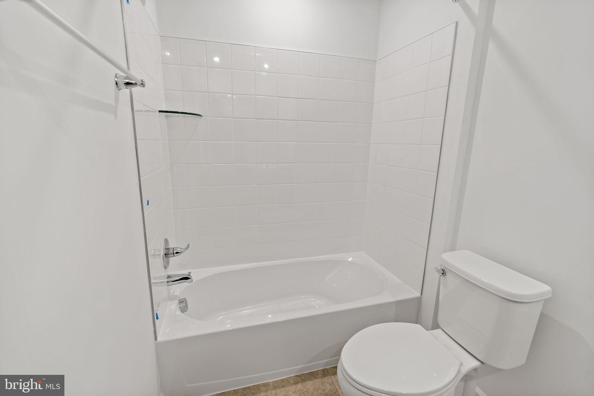 171 Grayling Road Inwood, WV 25428 - Photo 25 of 39 a white toilet and tub sitting next to a bathroom sink