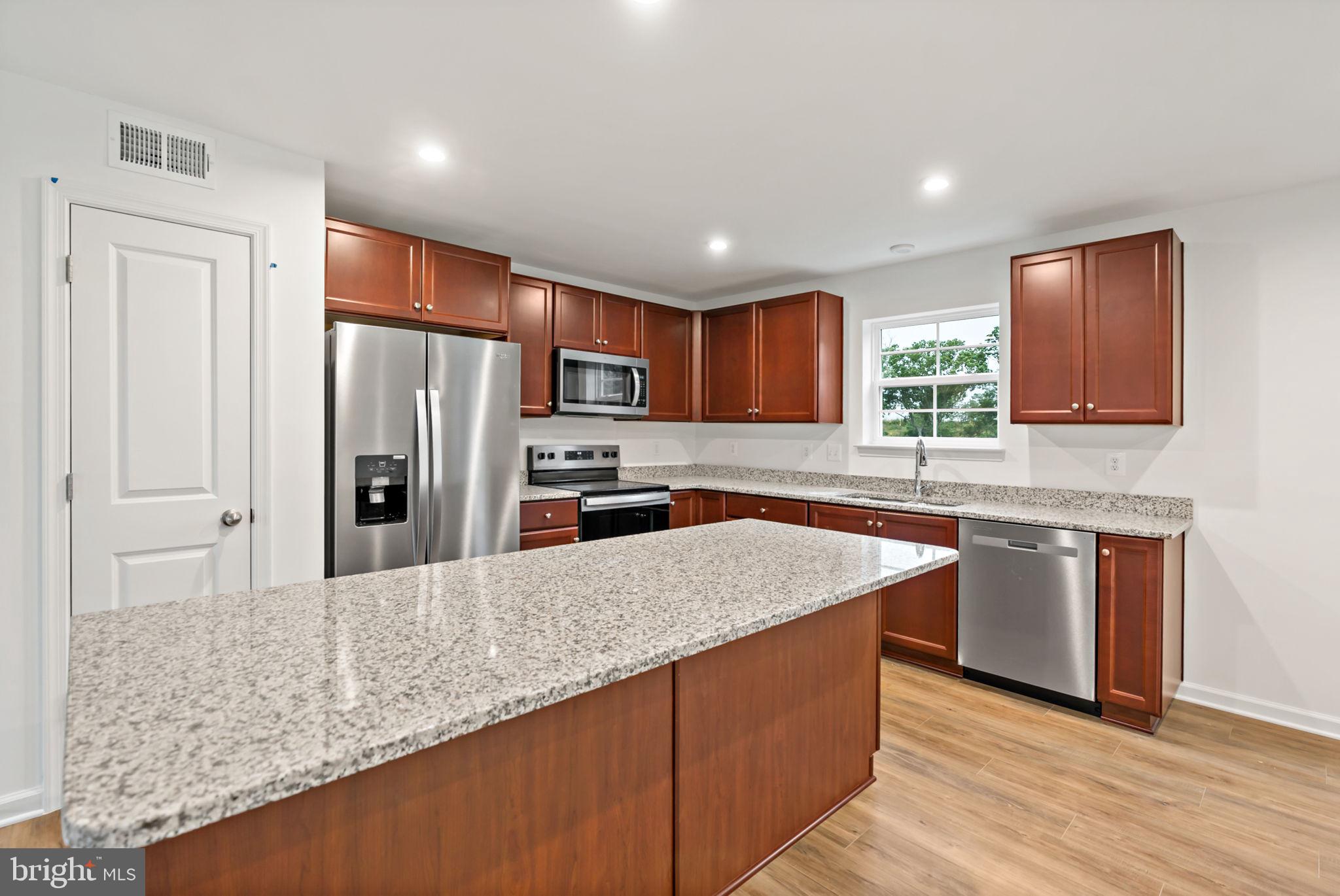 171 Grayling Road Inwood, WV 25428 - Photo 4 of 39 a kitchen with stainless steel appliances granite countertop a sink refrigerator and microwave