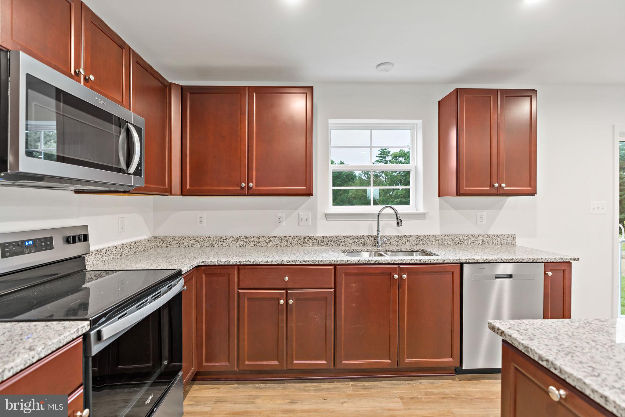 171 Grayling Road Inwood, WV 25428 - Photo 7 of 39 a kitchen with granite countertop cabinets stainless steel appliances and a sink
