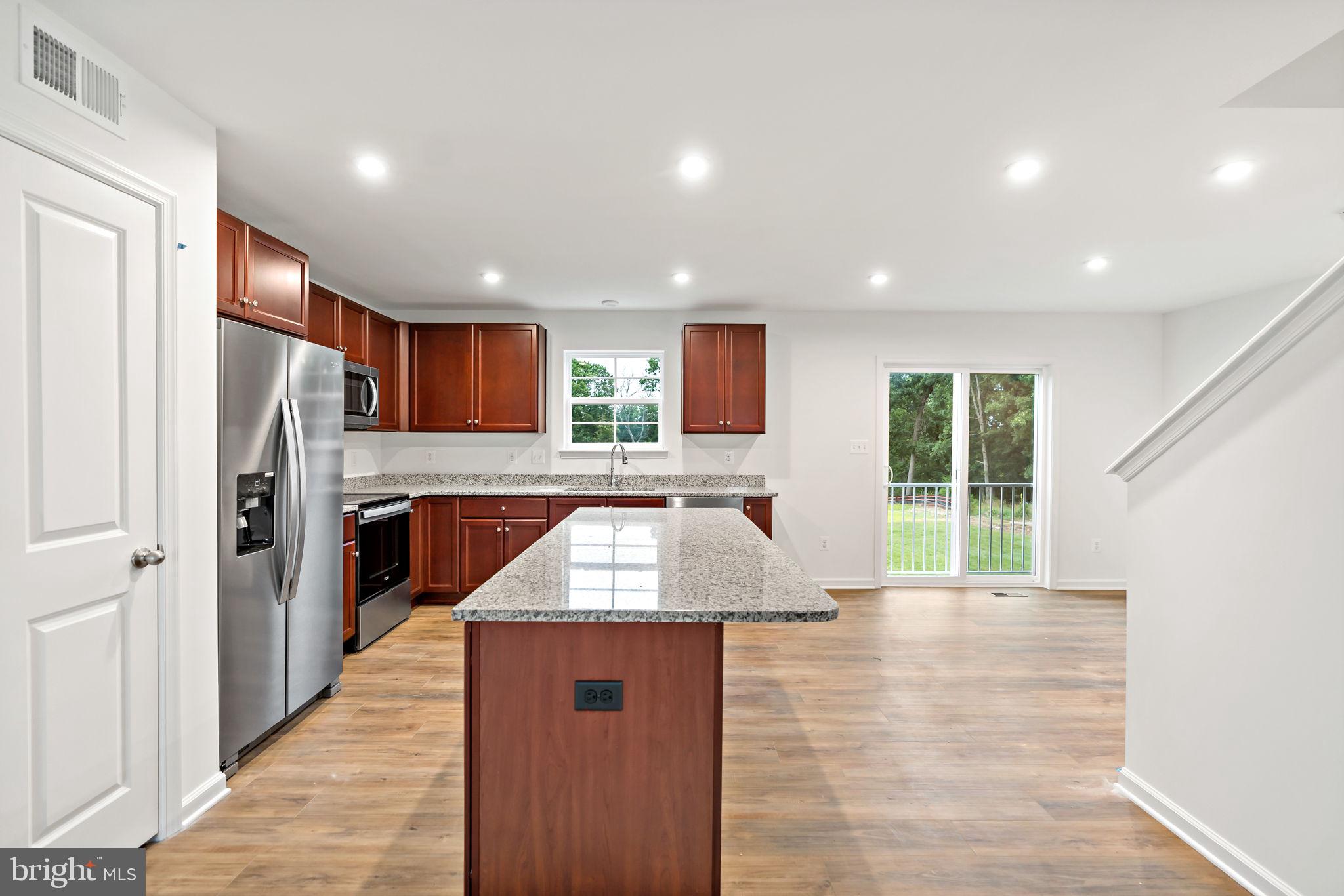 171 Grayling Road Inwood, WV 25428 - Photo 8 of 39 a kitchen with stainless steel appliances granite countertop a refrigerator sink and stove