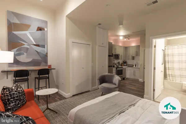 a bedroom with furniture and a large window
