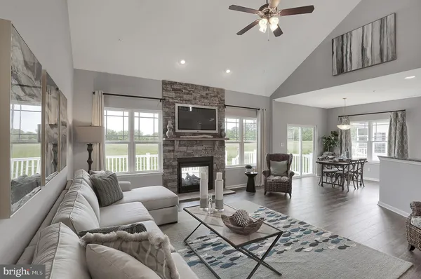 a living room with furniture fireplace and a large window