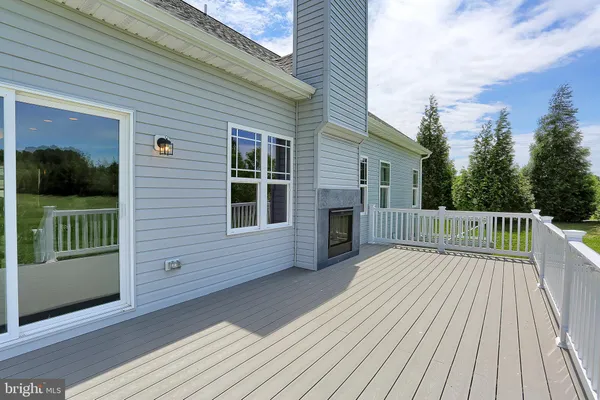 a view of a house with a wooden deck