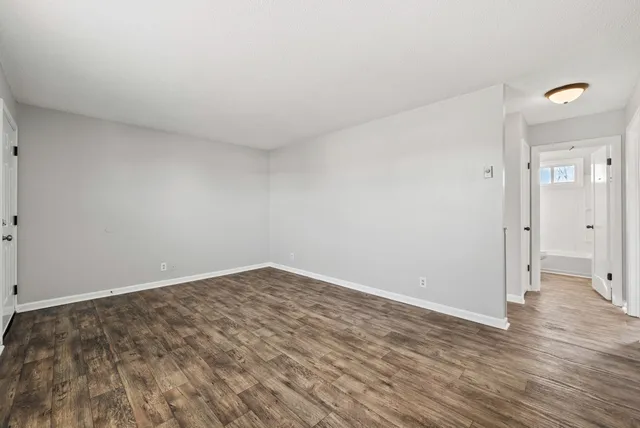 a view of an empty room and wooden floor