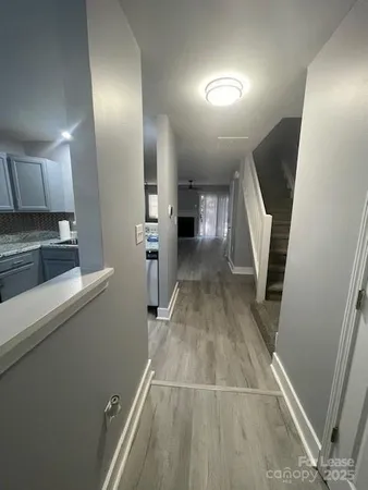 a view of a kitchen with wooden floor and electronic appliances