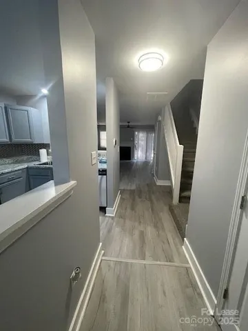 a view of a kitchen with wooden floor and electronic appliances