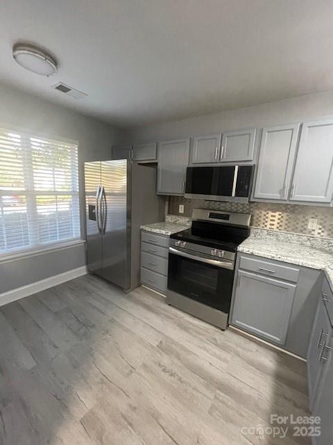 12315 Bluestem Lane Charlotte, NC 28277 - Photo 4 of 20 a kitchen with granite countertop a stove a sink and a refrigerator
