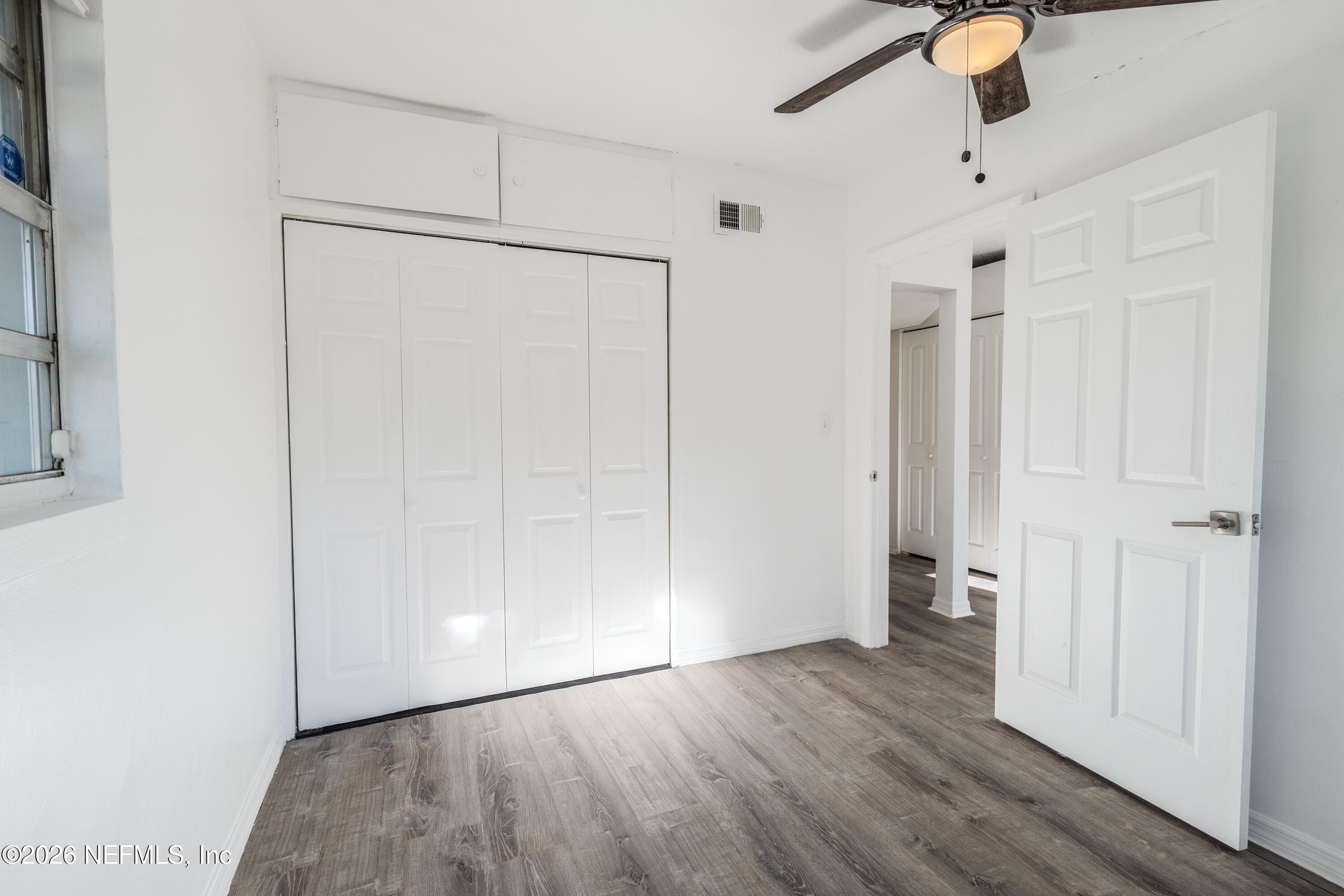 1841 Griflet Road Jacksonville, FL 32211 - Photo 11 of 20 a view of an empty room with wooden floor