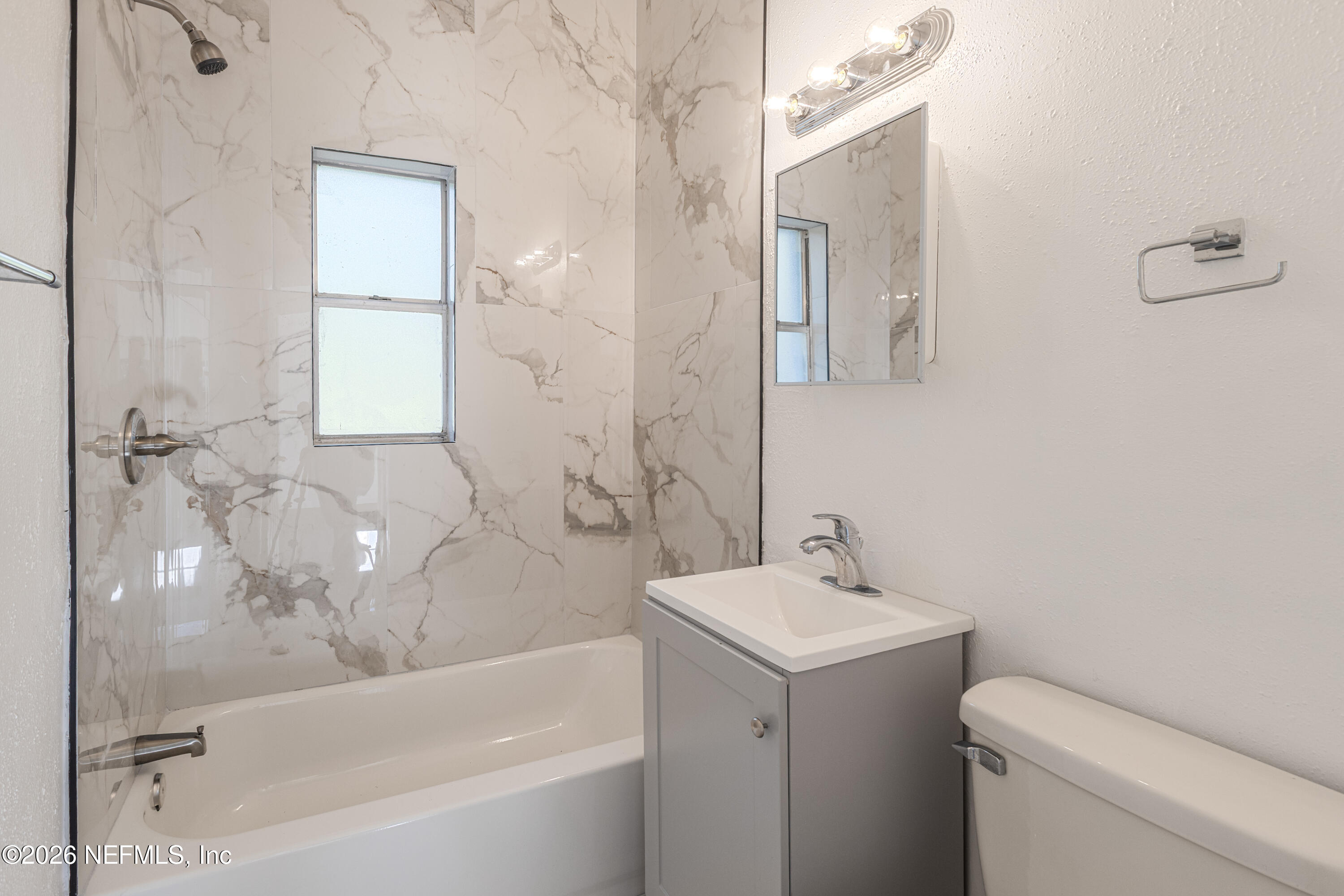 1841 Griflet Road Jacksonville, FL 32211 - Photo 12 of 20 a bathroom with a sink a toilet and shower