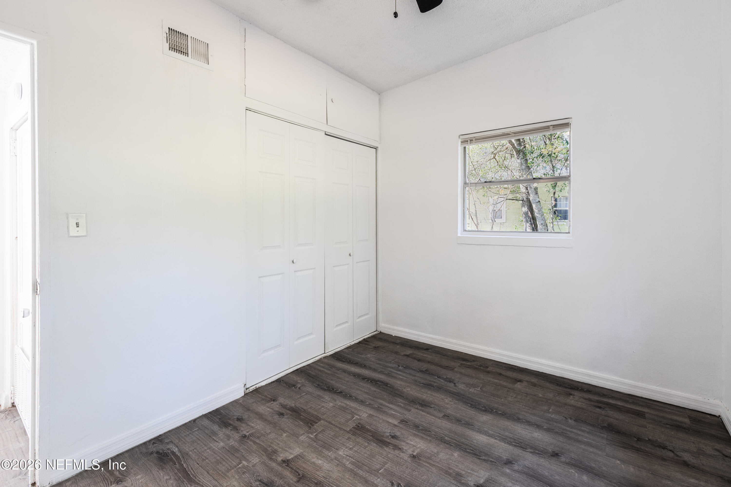 1841 Griflet Road Jacksonville, FL 32211 - Photo 16 of 23 a view of room with wooden floor and window
