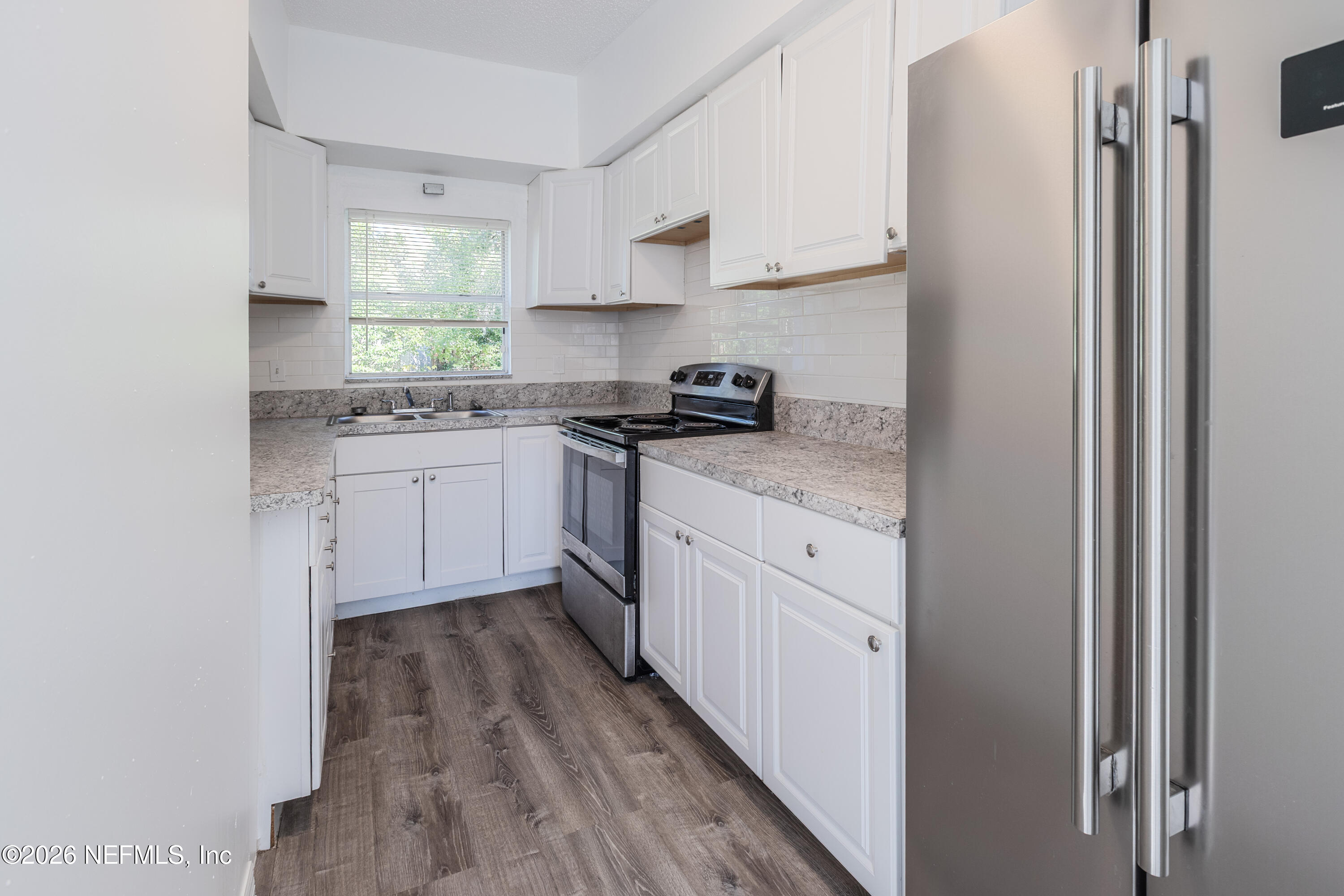 1841 Griflet Road Jacksonville, FL 32211 - Photo 5 of 20 a kitchen with stainless steel appliances granite countertop a stove a sink and a refrigerator