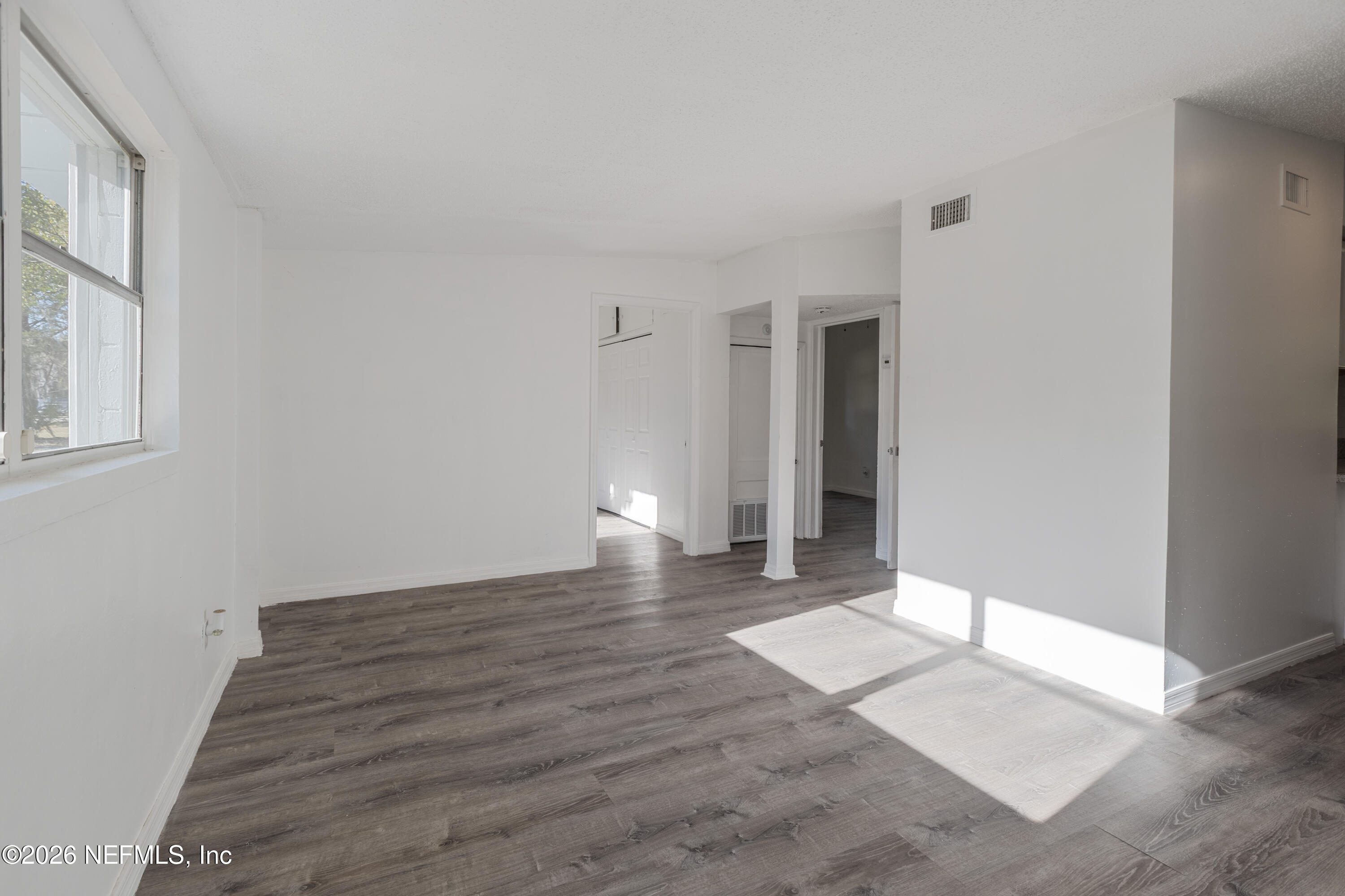 1841 Griflet Road Jacksonville, FL 32211 - Photo 5 of 23 a view of a big room with wooden floor and windows