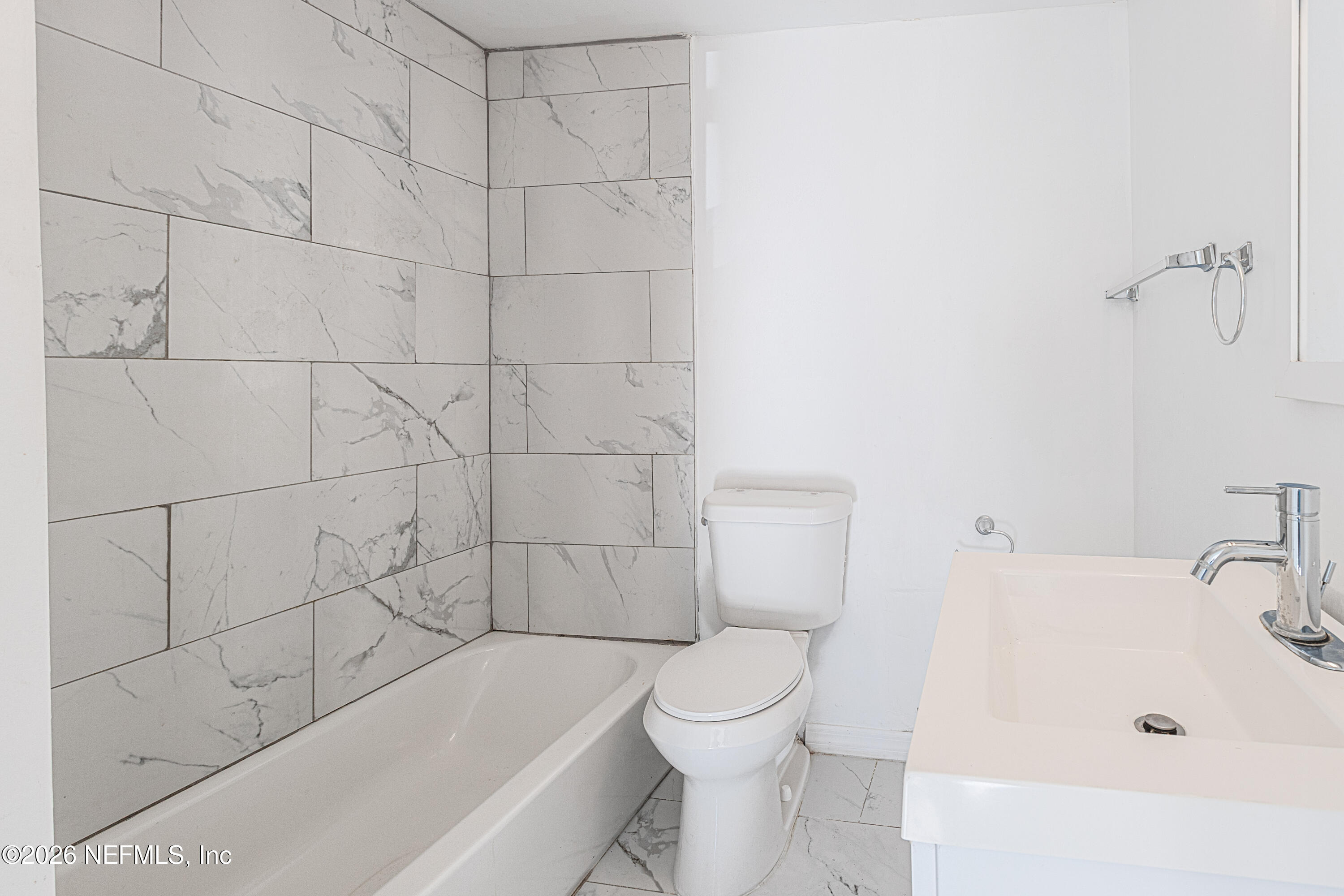 1841 Griflet Road Jacksonville, FL 32211 - Photo 7 of 20 a bathroom with a bathtub and toilet