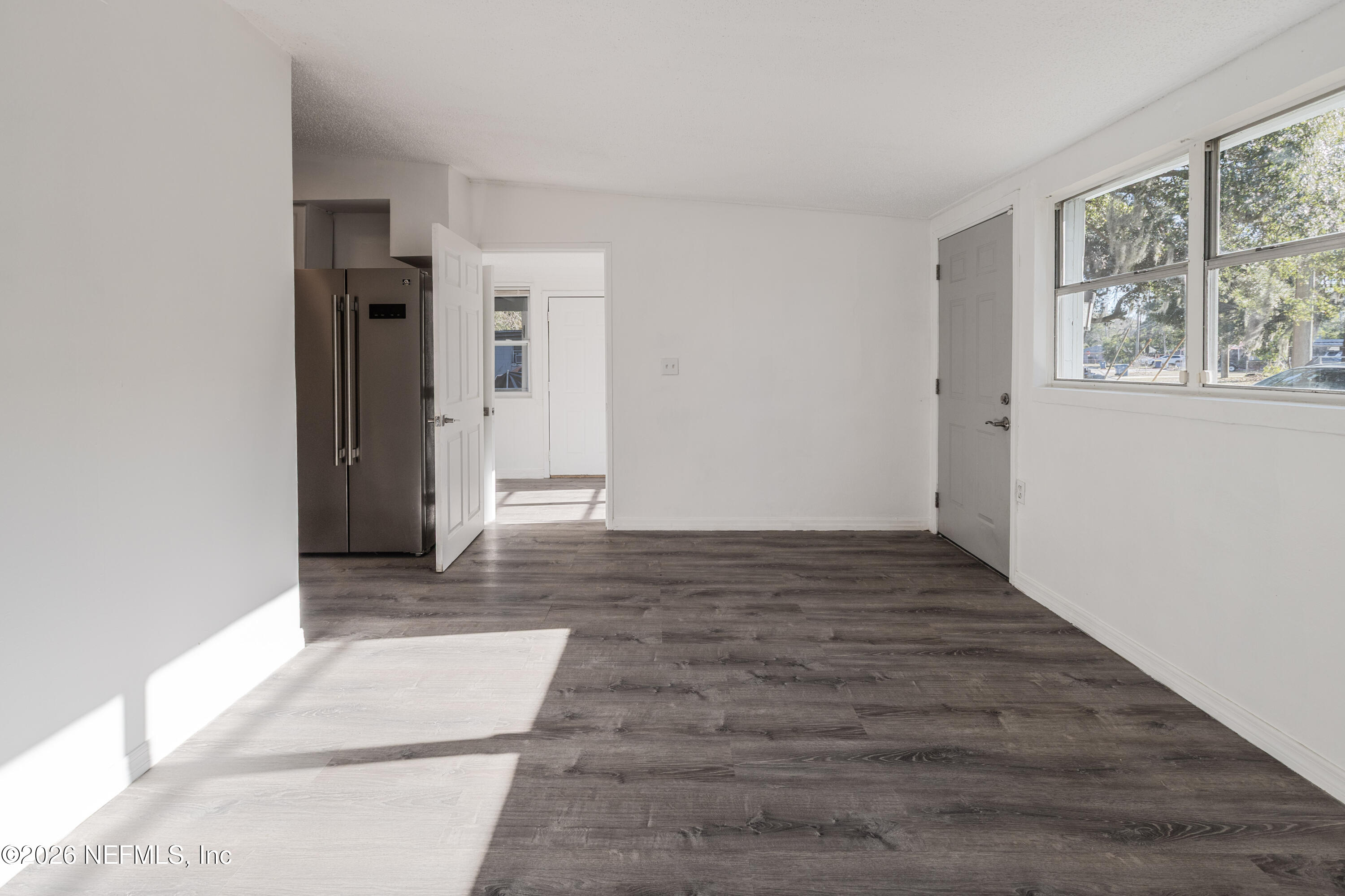 1841 Griflet Road Jacksonville, FL 32211 - Photo 9 of 20 a view of a hallway with wooden floor and windows