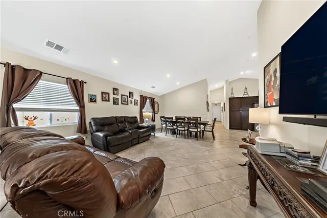 a bedroom with furniture and a flat screen tv