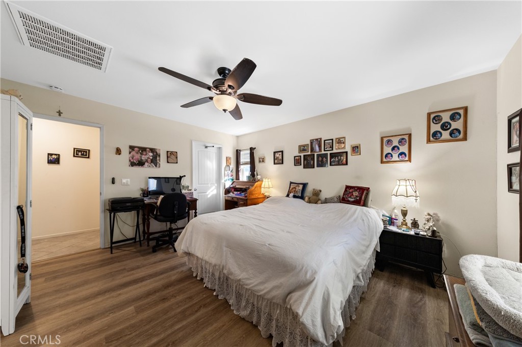 826 Avenida Del Rio San Jacinto, CA 92582 - Photo 14 of 36 a bed room with a bed mirror and a chair