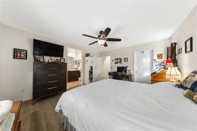 a bed room with a bed a television and dresser