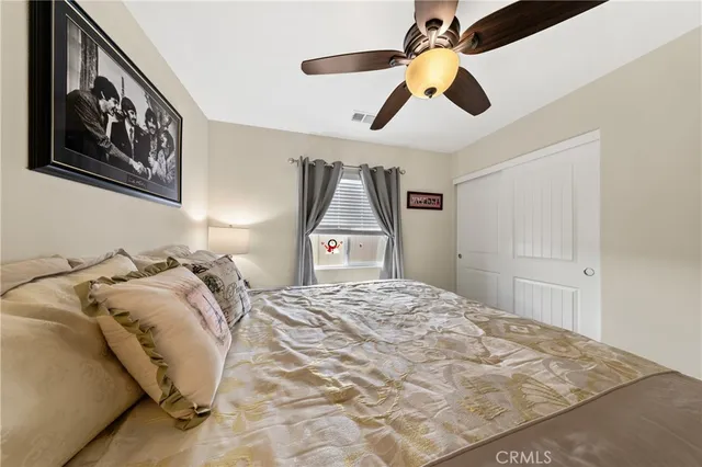 a bedroom with a bed and a painting on the wall